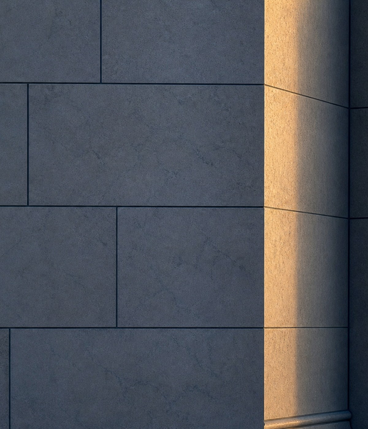 Dark ashlar stone wall with a warm sunlit pier at the corner.
