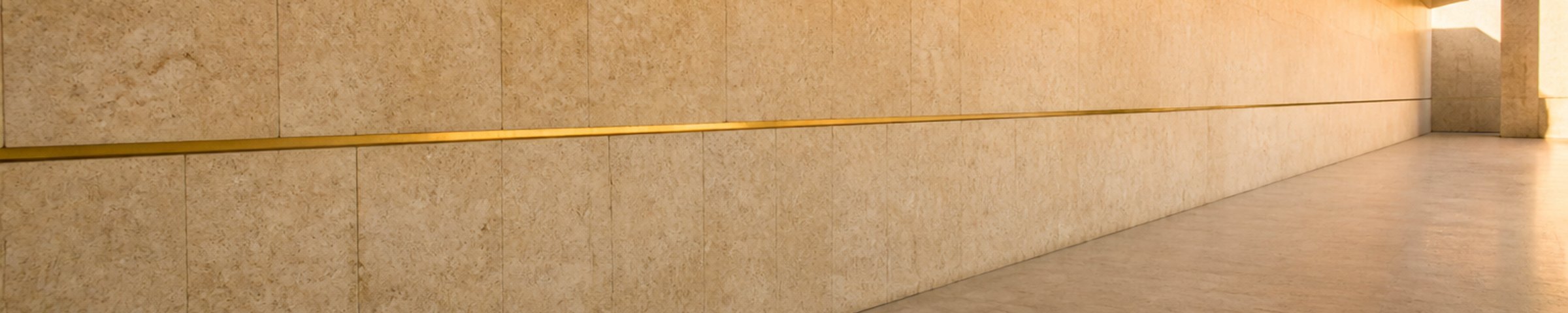A brass inlay line running the length of a limestone wall.